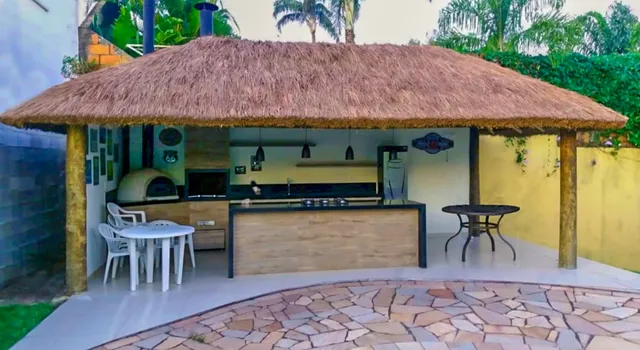 Quiosque de sapê cobrindo uma área gourmet com churrasqueira — projeto S-130